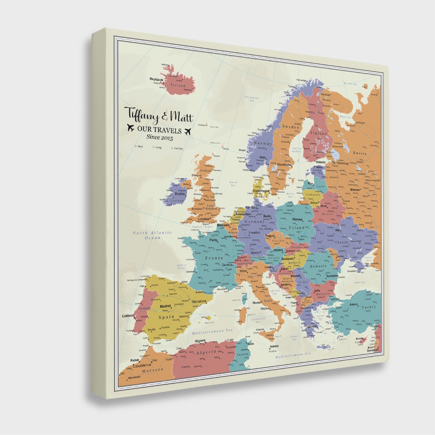 Personalized gallery wrapped Europe push pin travel map canvas with tan oceans and vibrant country colors, angled view