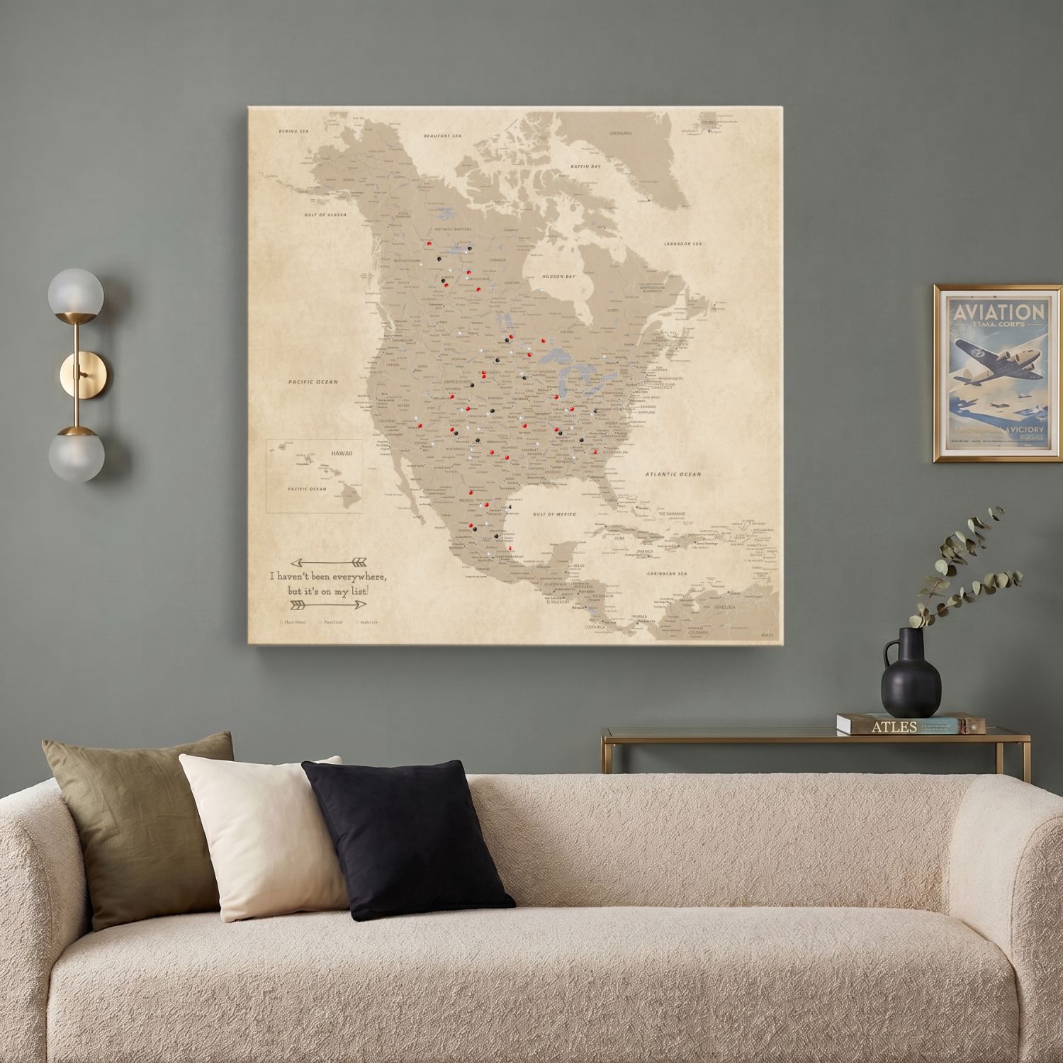 Vintage North America push pin travel map canvas hung above modern living room sofa