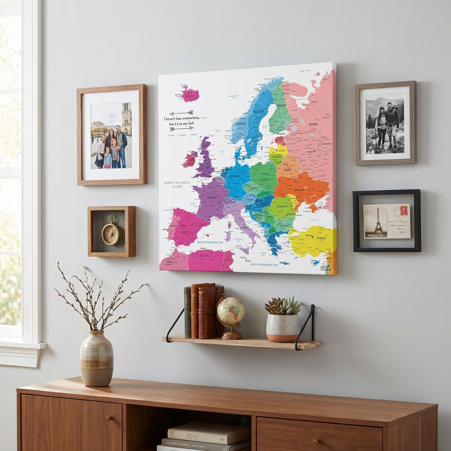Colorful Europe travel map canvas gallery wall display with travel photos compass and globe decor