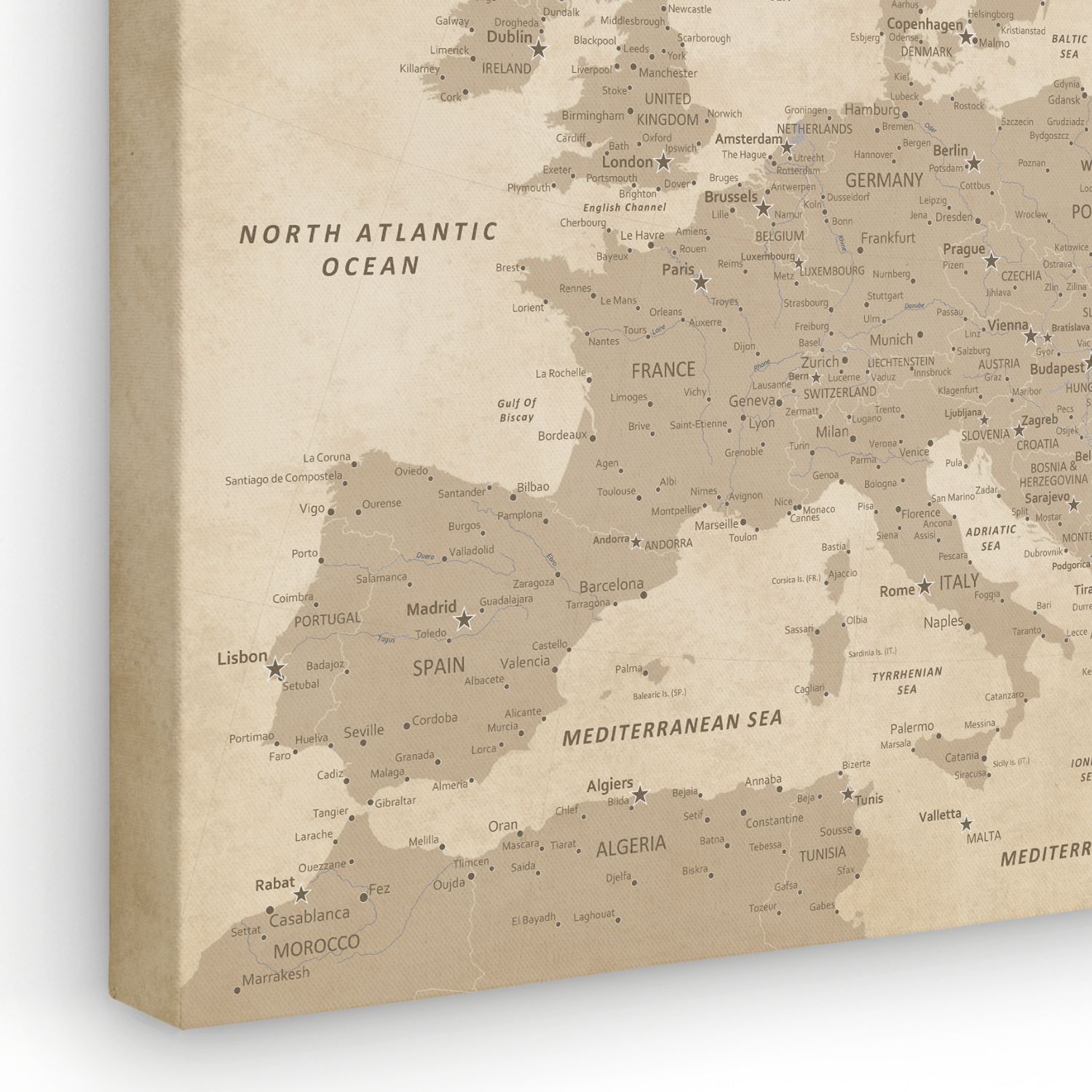 Angled view of vintage Europe canvas travel map with pins showing detailed city labels in warm beige tones