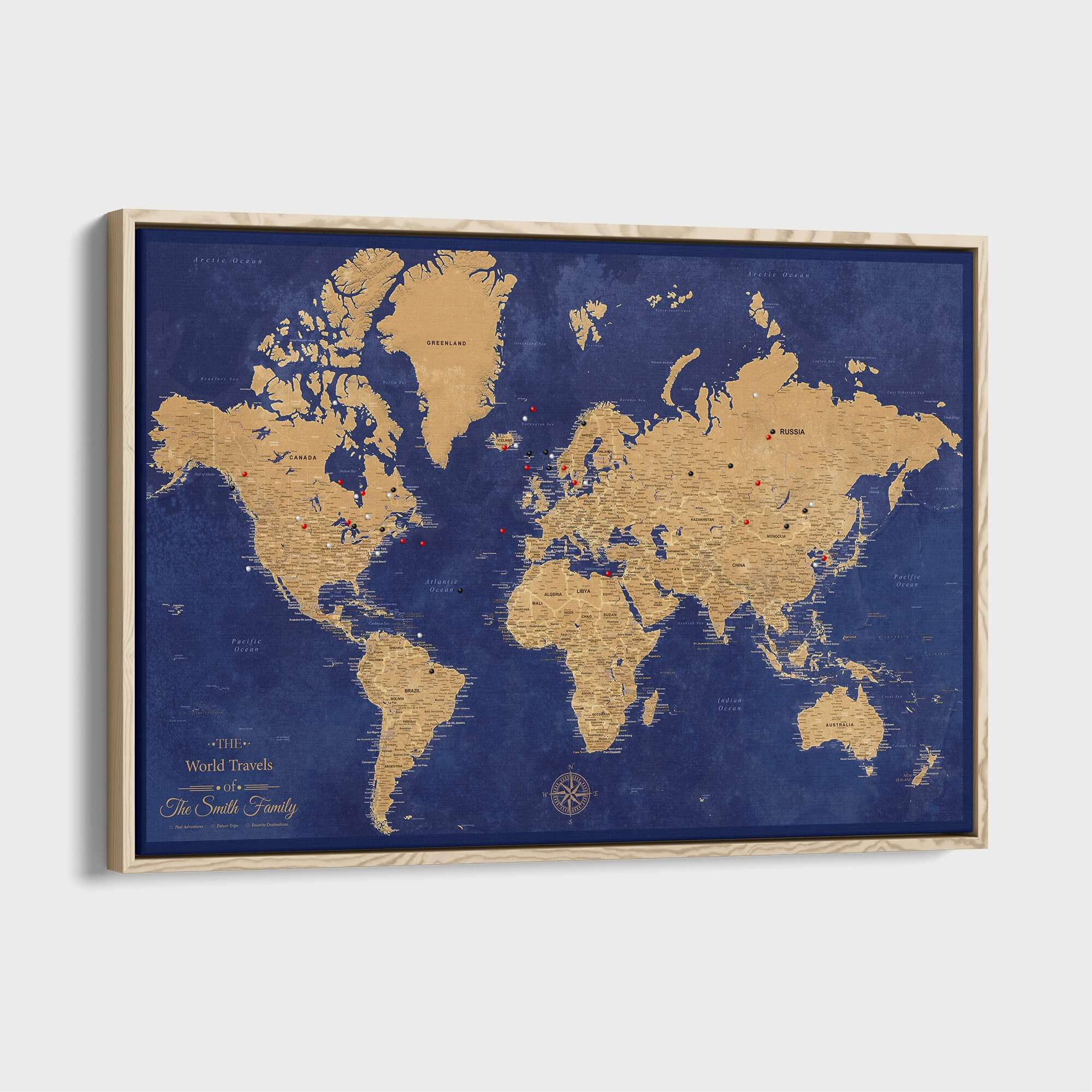 Personalized gold and navy framed canvas world travel push pin map with compass rose and light wood frame