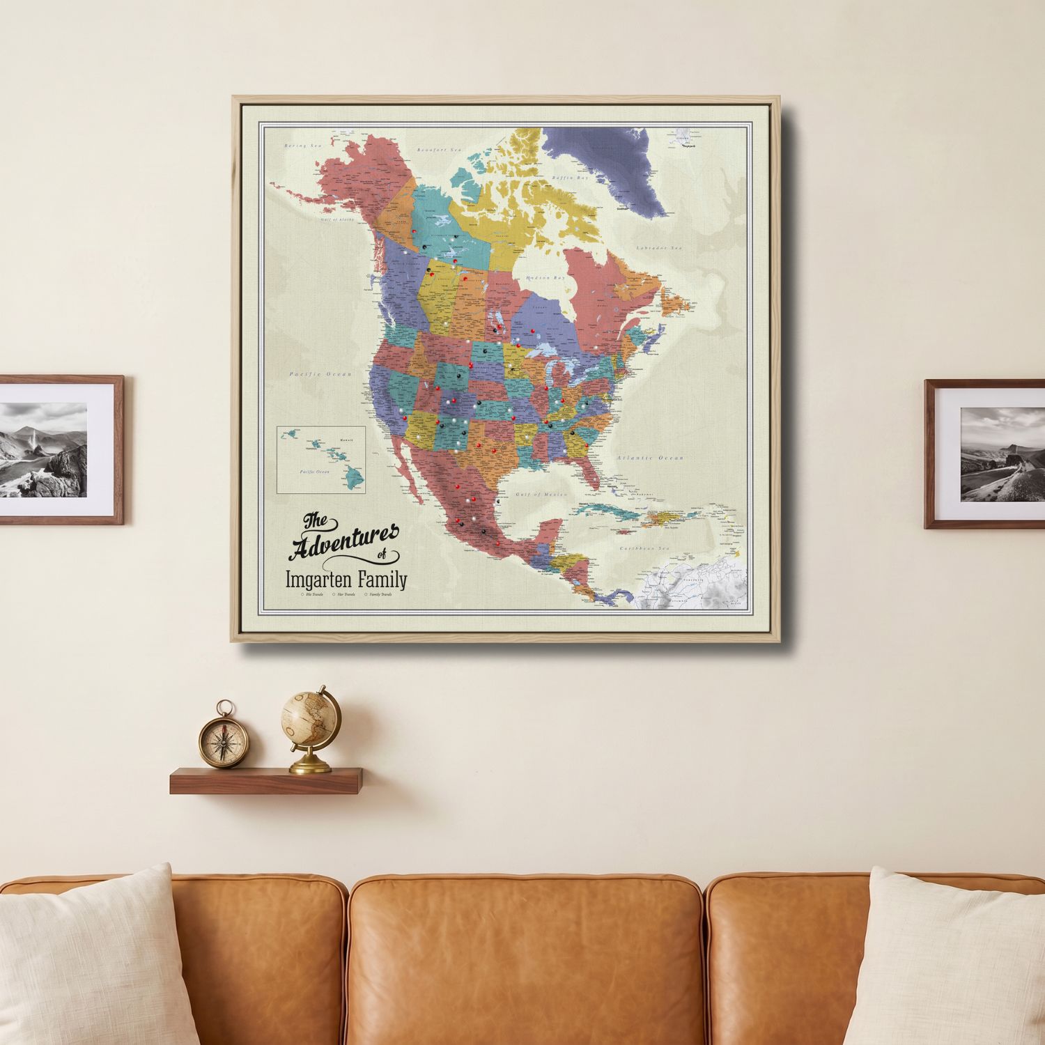 Personalized North America push pin travel map canvas in wood frame hung above leather sofa