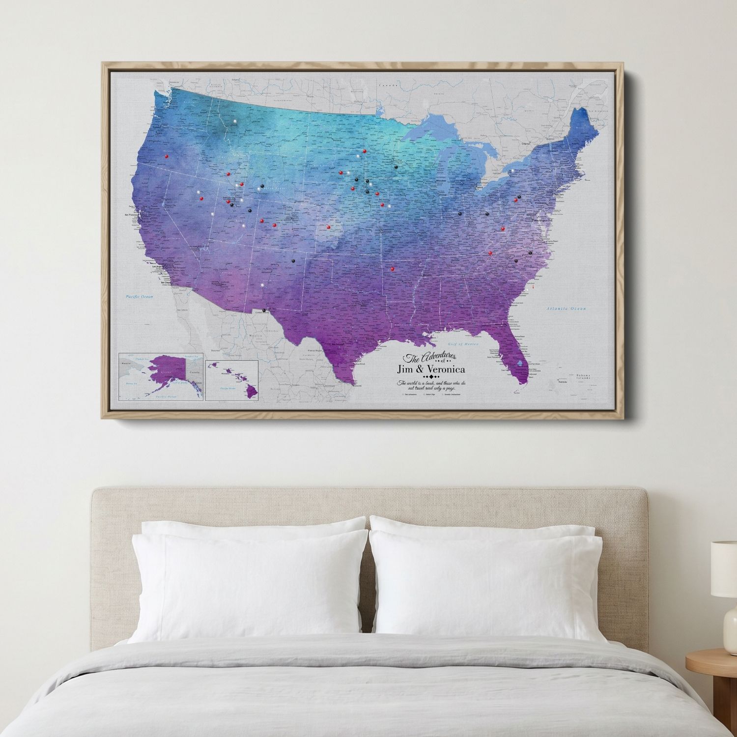 Vibrant violet watercolor USA travel map canvas with pins displayed above bedroom bed