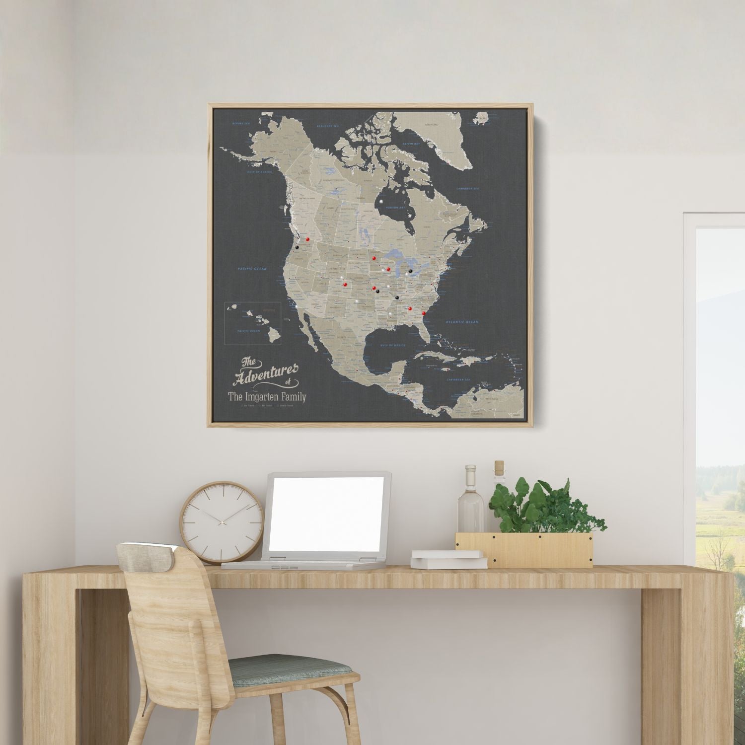 Personalized earth toned North America travel map with push pins in natural wood frame above desk