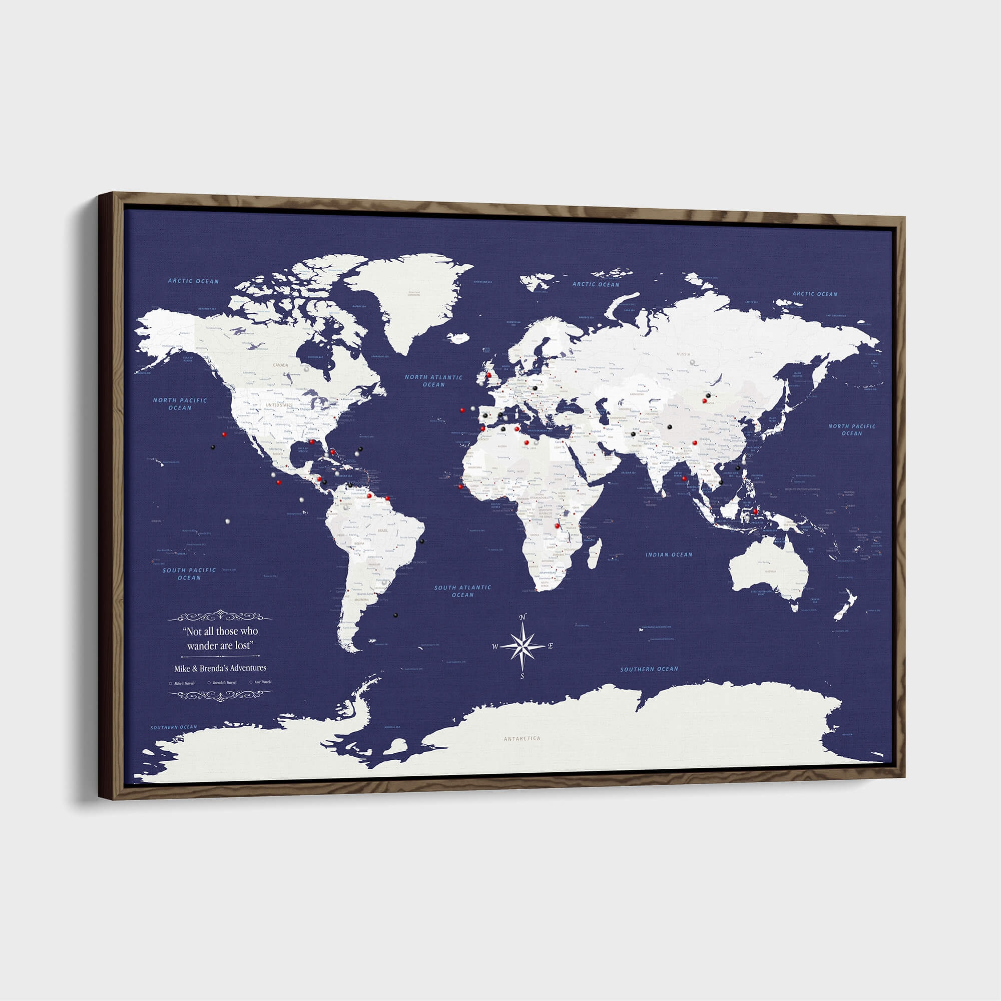 Navy Explorers world travel map canvas with push pins in wooden frame mounted on wall