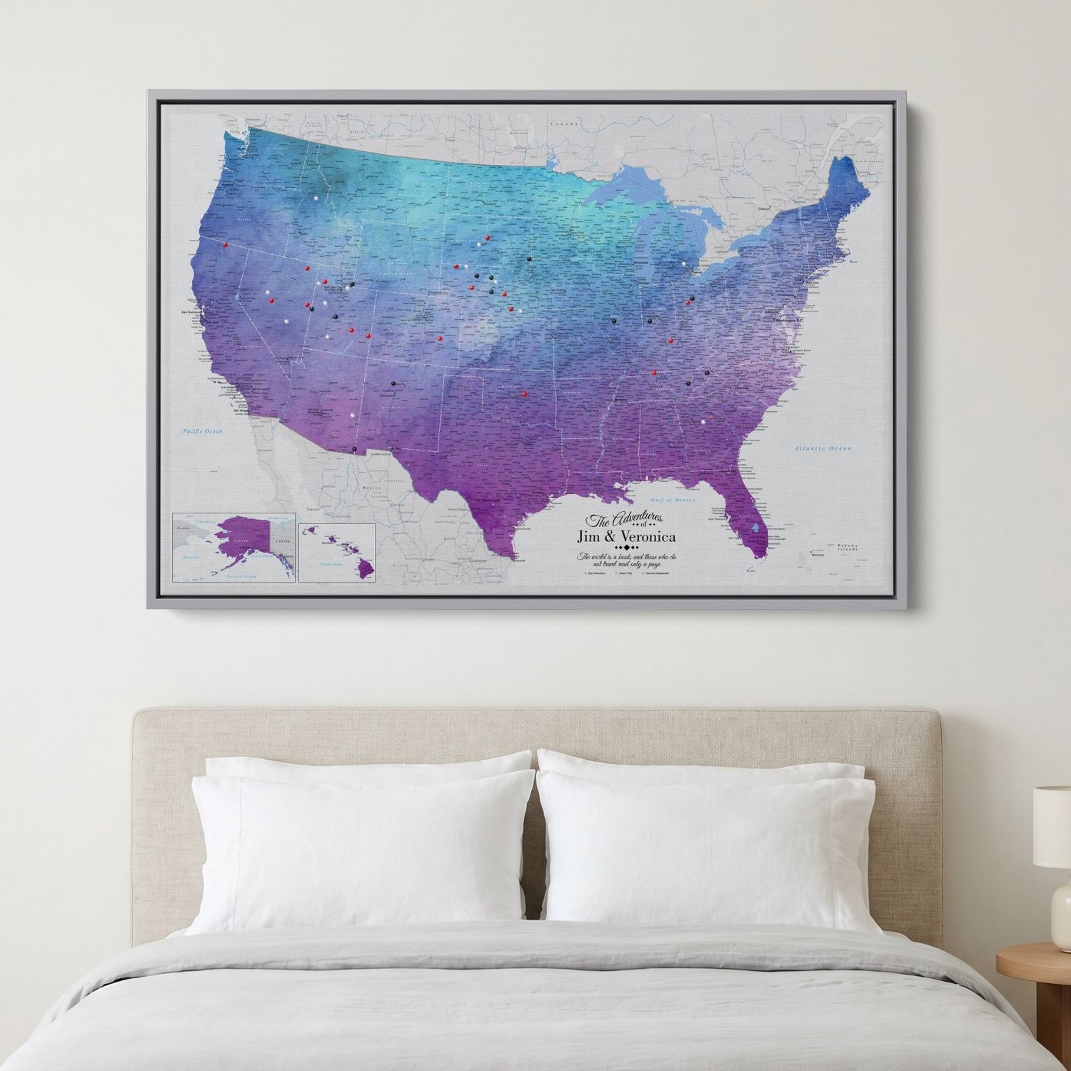 Vibrant violet watercolor USA travel map canvas with pins hanging above bedroom bed