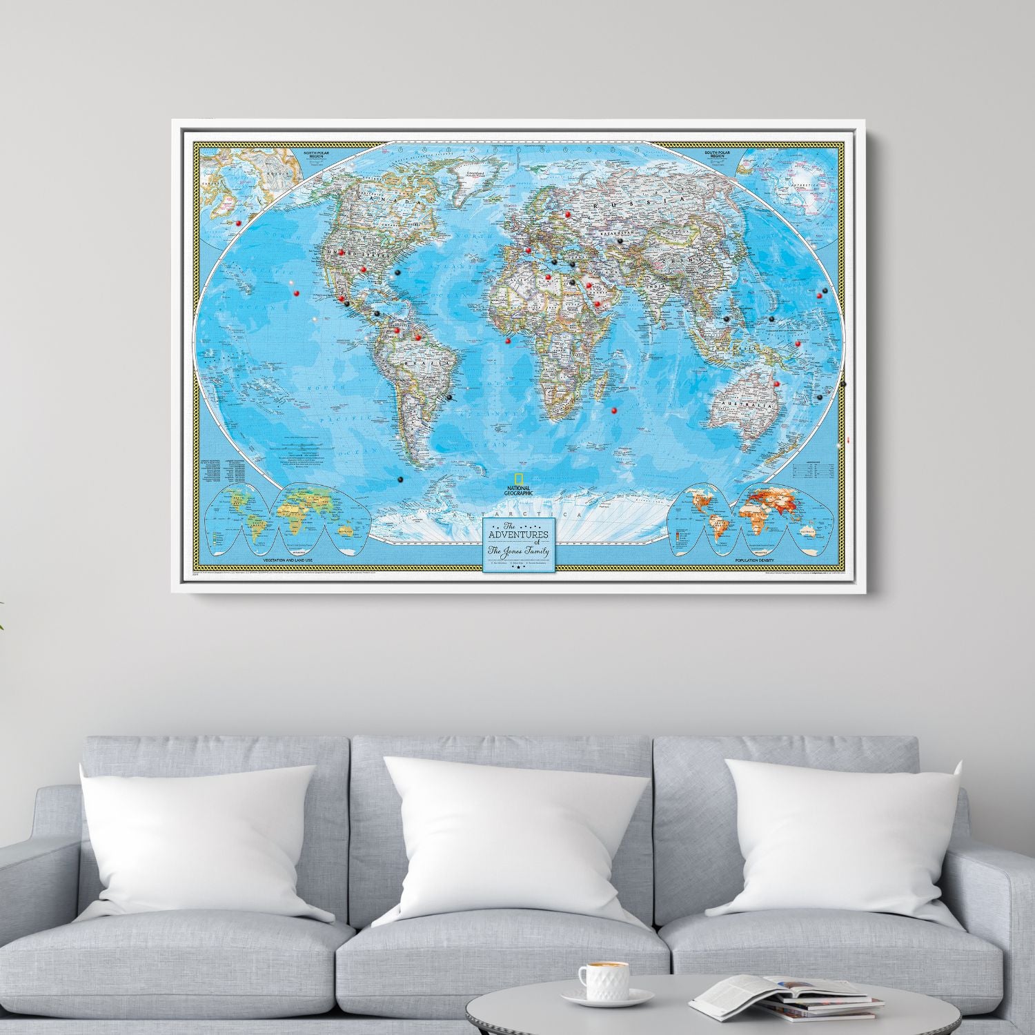 Personalized classic world travel map canvas with red and black pins hung above gray sofa in living room