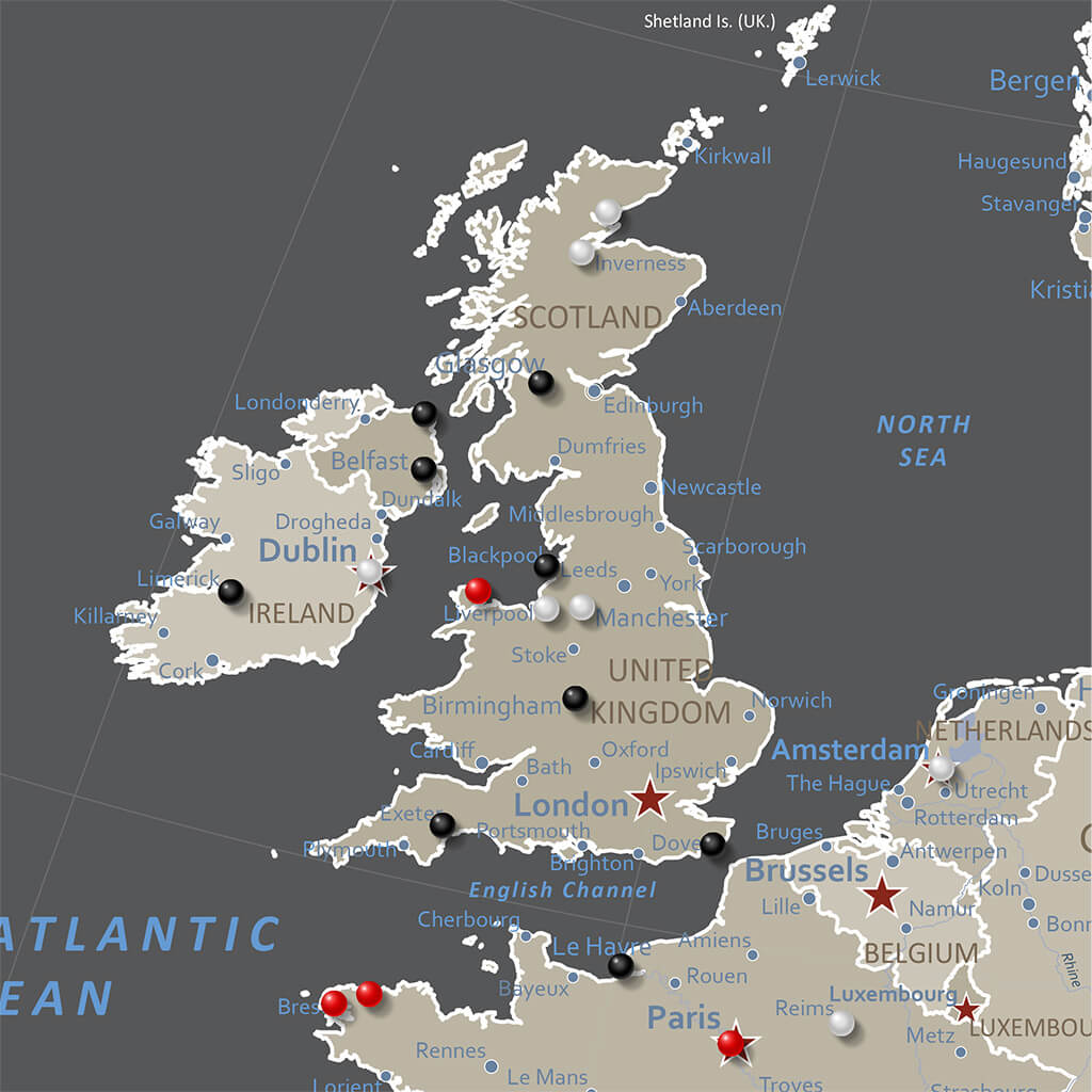 Earth toned Europe travel map close-up showing UK Ireland France with red and black pins