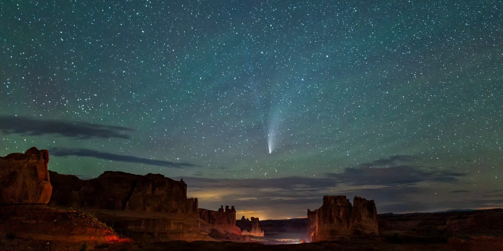 Neowise C2020 F3 Comet silhouetted against the Courthouse Towers valley from the La Sal Mountains Viewpoint in Arches National Park in Moab, Utah.
