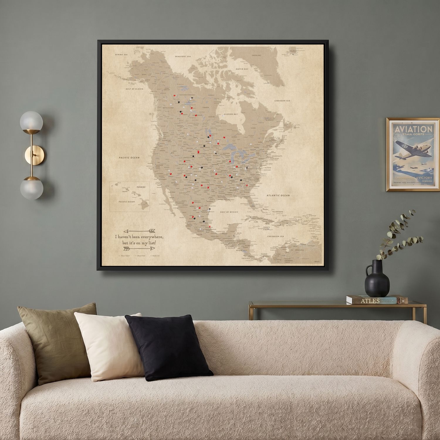 Vintage North America push pin travel map canvas hanging above modern living room sofa