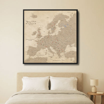 Vintage Europe travel map canvas with pins displayed above bed in neutral beige bedroom décor