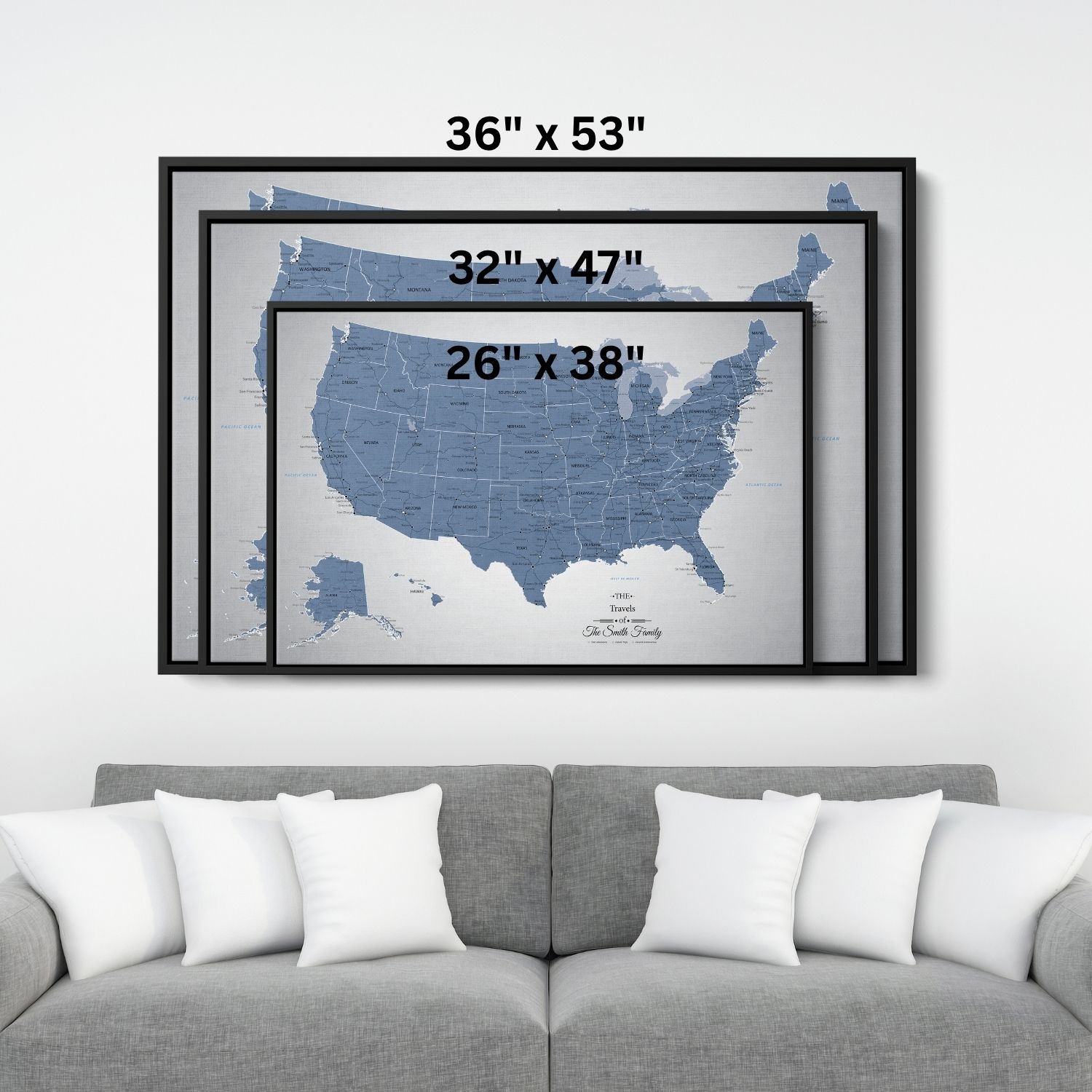 Three size comparison frames of blue ice USA push pin canvas travel map displayed above gray sofa