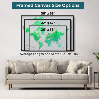 Three black framed emerald watercolor world map canvas size options displayed above beige sofa