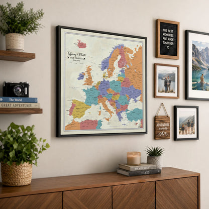 Personalized tan ocean Europe canvas push pin travel map in black frame displayed on living room wall