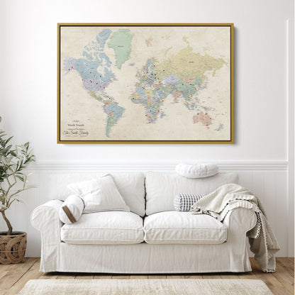 Personalized Sandy Dreams world travel map canvas with red and black push pins in gold frame above white sofa