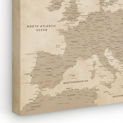 Angled view of vintage Europe canvas travel map with pins showing detailed city labels in warm beige tones