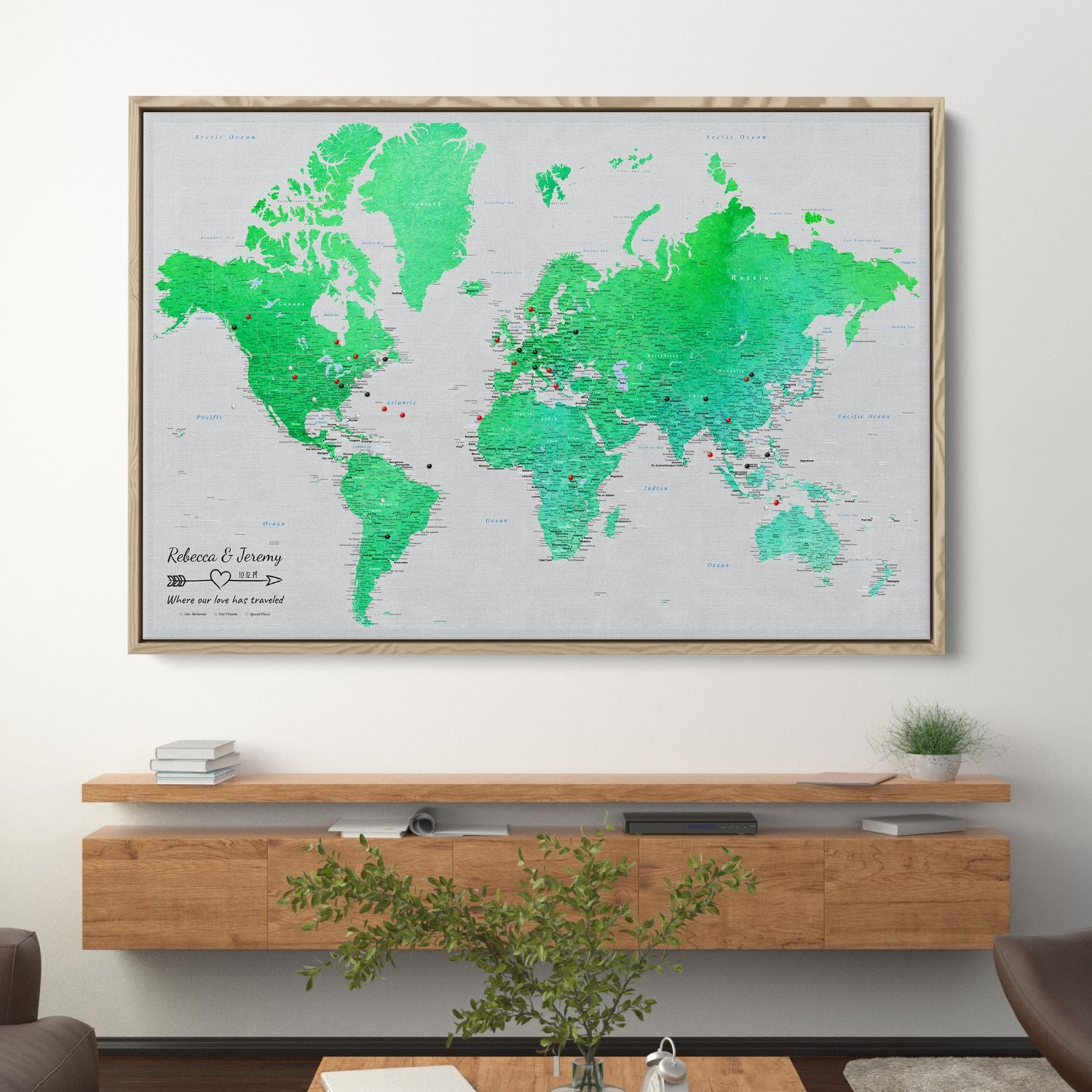 Enchanting Emerald watercolor world travel map canvas in wood frame hung above modern console