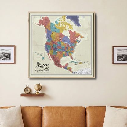 Personalized North America push pin travel map canvas in wood frame hung above leather sofa