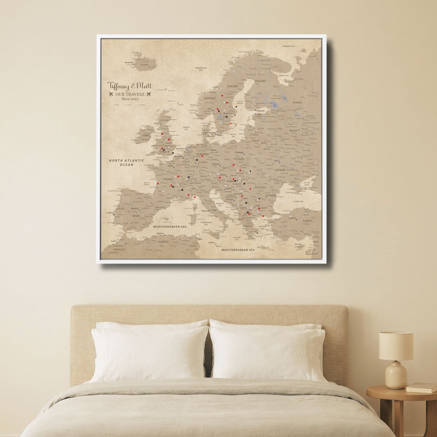 Vintage Europe travel map canvas with pins displayed above bedroom bed in white frame