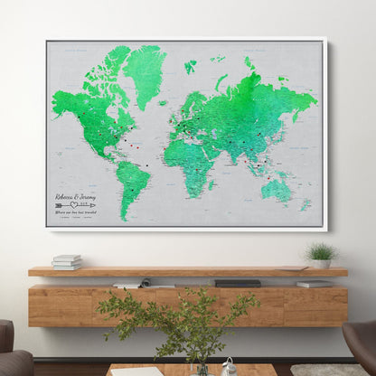 Enchanting Emerald watercolor world travel map canvas with pins displayed above wooden shelf