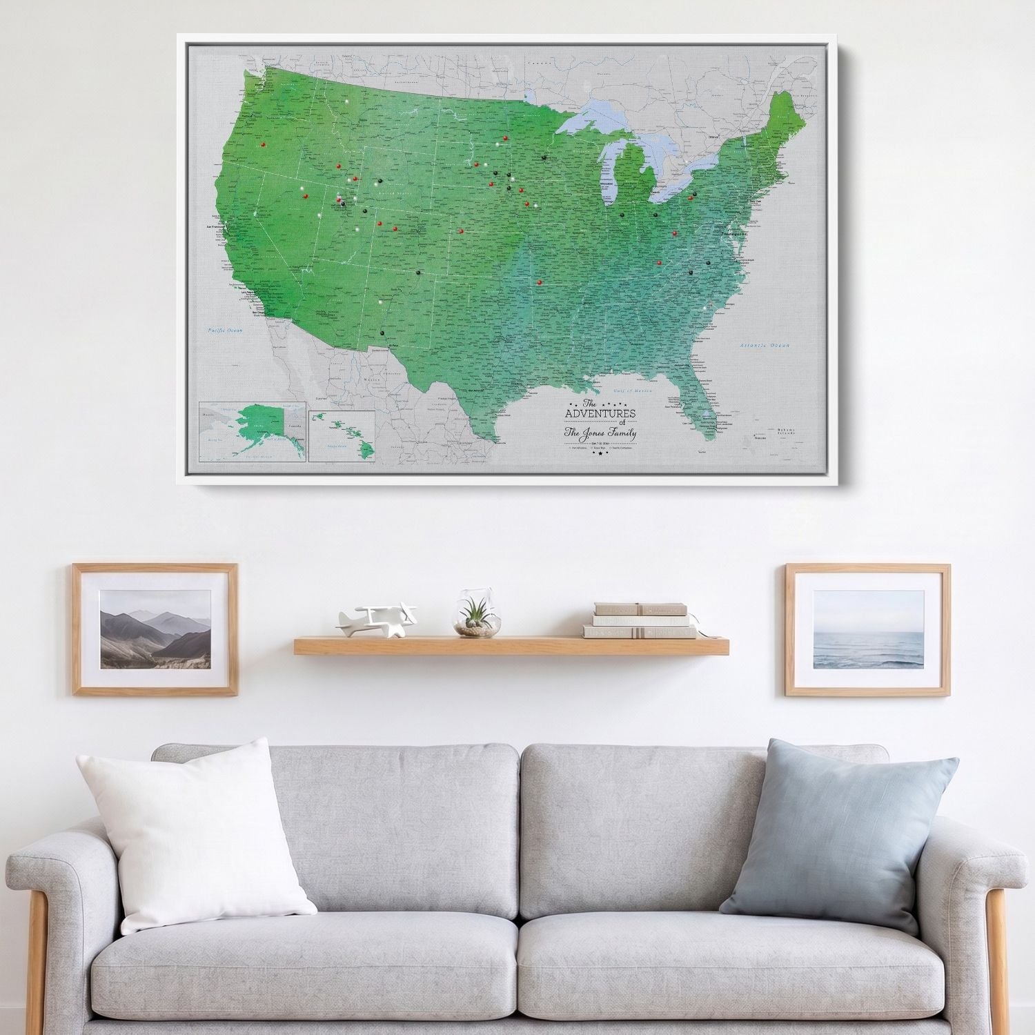 Enchanting Emerald watercolor USA travel map canvas with red and black pins hung above gray sofa in living room