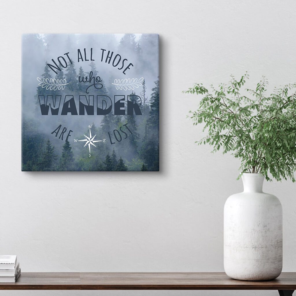Famous &quot;Not All Those Who Wander Are Lost&quot; Quote over a Misty Forest Scene